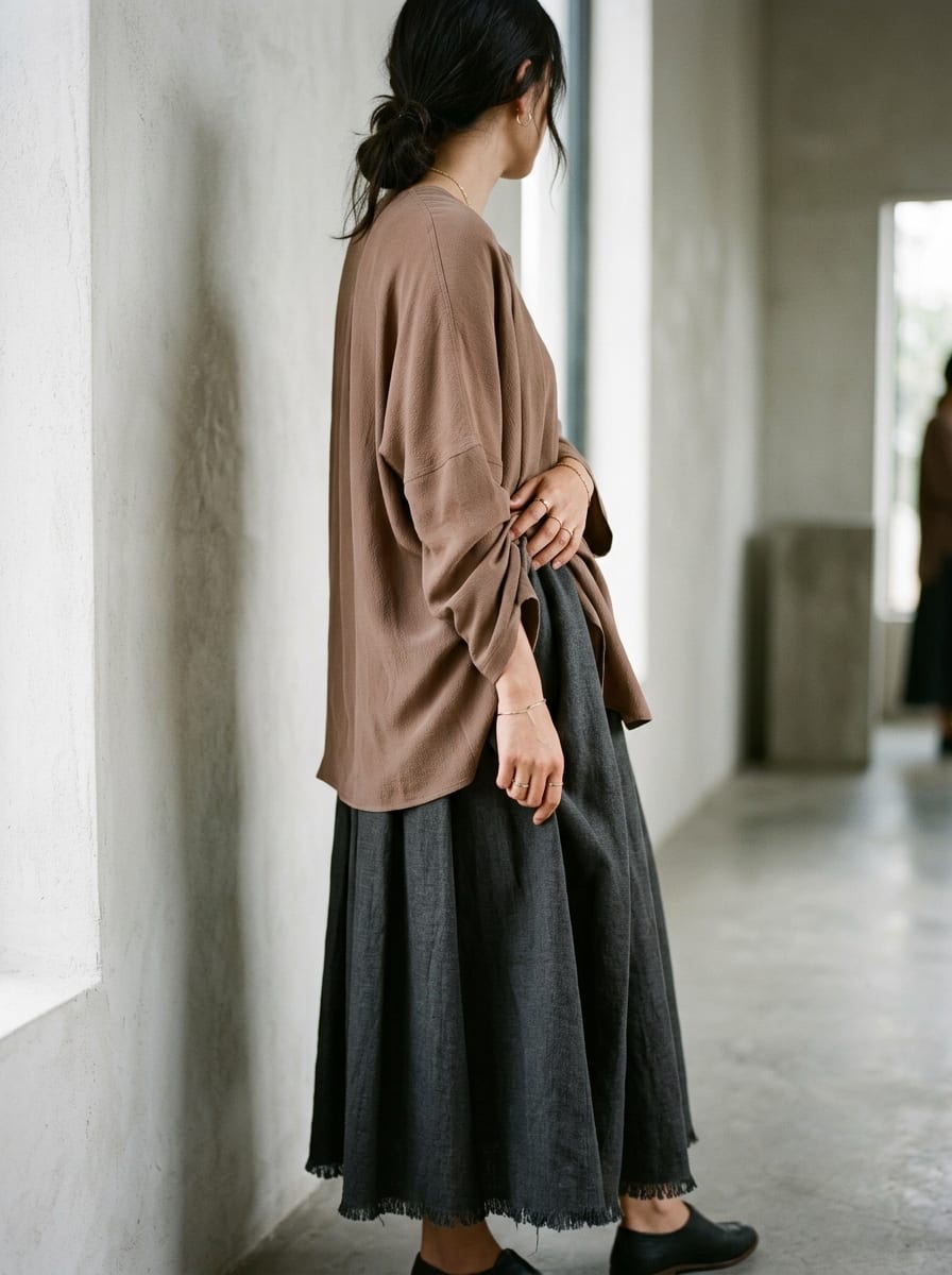 Editorial fashion model wearing soft clay colored fabrics